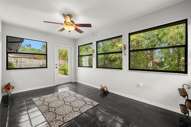 1047 Deer Hollow Way, Sarasota, FL 34232 - interior space with plenty of natural light, a ceiling fan, baseboards, and dark tile patterned flooring