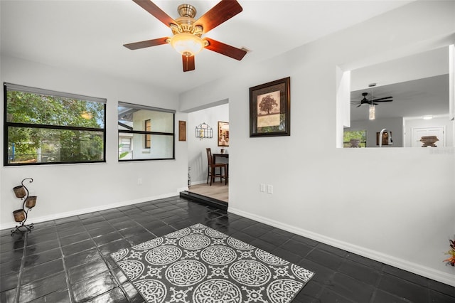 1047 Deer Hollow Way, Sarasota, FL 34232 - empty room with tile patterned floors, baseboards, a sink, and ceiling fan