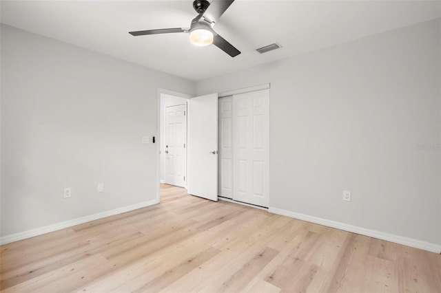 1047 Deer Hollow Way, Sarasota, FL 34232 - unfurnished bedroom with baseboards, a closet, visible vents, and light wood-style flooring