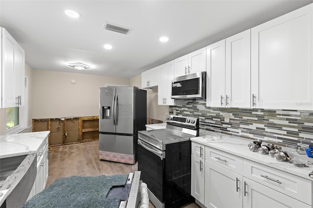 kitchen with white cabinets, visible vents, and stainless steel appliances
