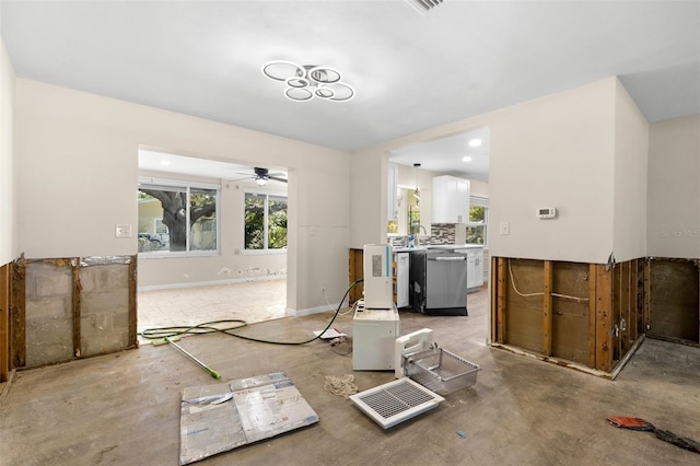 living room featuring baseboards and a ceiling fan