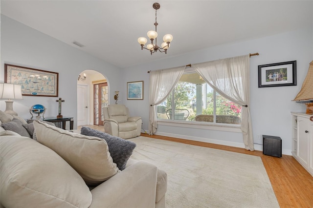 4490 38th Way S, Saint Petersburg, FL 33711 - living area with a notable chandelier, baseboards, light wood-type flooring, visible vents, and arched walkways