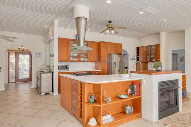 4490 38th Way S, Saint Petersburg, FL 33711 - kitchen with open shelves, brown cabinets, a ceiling fan, and stainless steel appliances