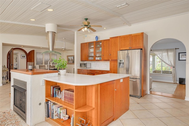 4490 38th Way S, Saint Petersburg, FL 33711 - kitchen featuring light tile patterned floors, a large island with sink, a ceiling fan, open shelves, and stainless steel appliances