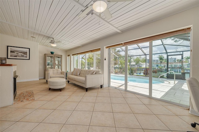 4490 38th Way S, Saint Petersburg, FL 33711 - living room with baseboards, a ceiling fan, light tile patterned flooring, and a sunroom