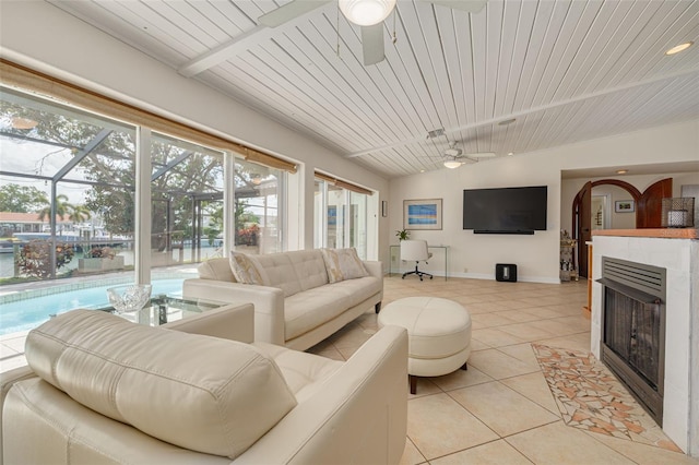 4490 38th Way S, Saint Petersburg, FL 33711 - living area featuring light tile patterned flooring, ceiling fan, a fireplace, and baseboards