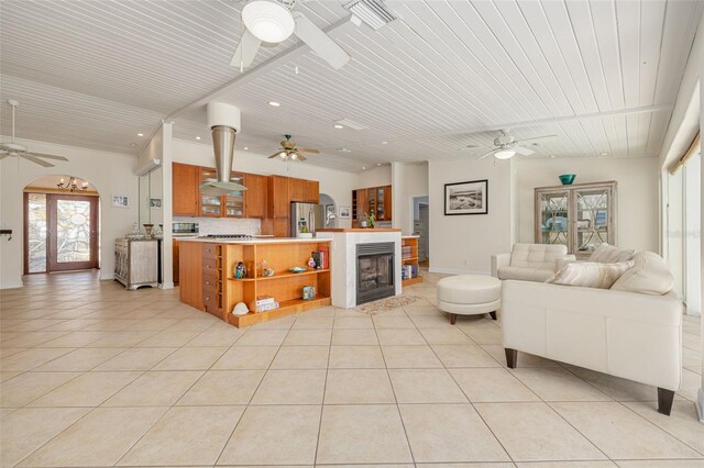 4490 38th Way S, Saint Petersburg, FL 33711 - living room with light tile patterned flooring, wood ceiling, ceiling fan, and a fireplace