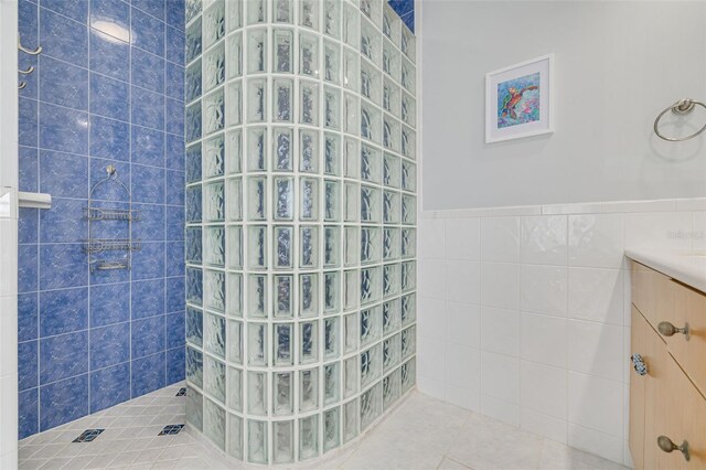 4490 38th Way S, Saint Petersburg, FL 33711 - full bath with a walk in shower, vanity, a wainscoted wall, tile walls, and tile patterned floors
