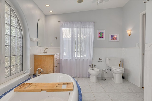4490 38th Way S, Saint Petersburg, FL 33711 - full bath with tile walls, a freestanding bath, plenty of natural light, and tile patterned flooring