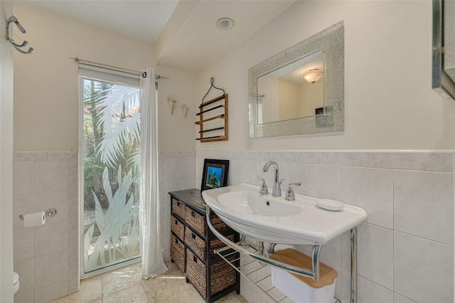 4490 38th Way S, Saint Petersburg, FL 33711 - bathroom featuring toilet, tile walls, and a wainscoted wall