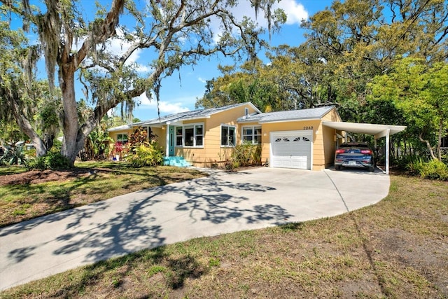 2049 Broadway, Clearwater, FL 33755 - ranch-style house with concrete driveway, an attached garage, and a front lawn