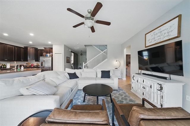 living area featuring light tile patterned floors, recessed lighting, a ceiling fan, and stairway