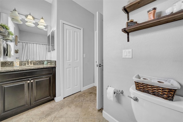 bathroom featuring vanity, tile patterned flooring, toilet, a shower with shower curtain, and baseboards