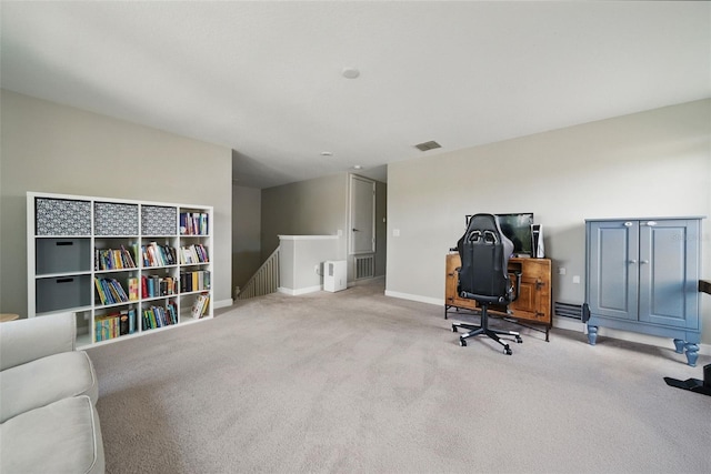 carpeted home office featuring visible vents and baseboards