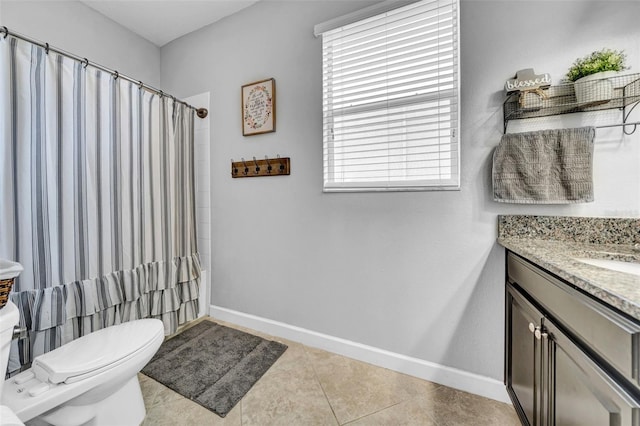 full bathroom featuring tile patterned flooring, toilet, vanity, and baseboards
