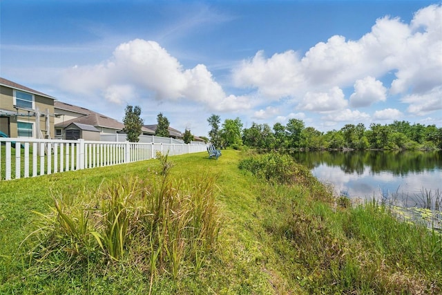 exterior space featuring a water view and fence