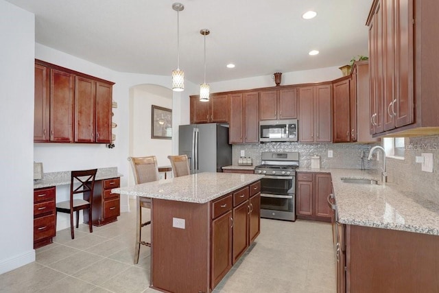 1214 Florablu Dr, Seffner, FL 33584 - kitchen with stainless steel appliances, backsplash, a kitchen breakfast bar, a center island, and recessed lighting