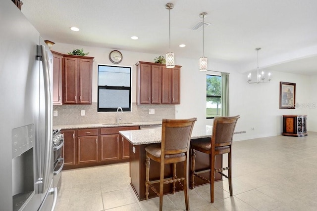 1214 Florablu Dr, Seffner, FL 33584 - kitchen with stainless steel appliances, tasteful backsplash, light stone counters, light tile patterned flooring, and recessed lighting