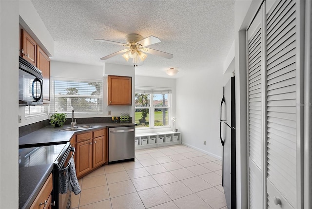 6191 Bahia Del Mar Blvd Unit 204, Saint Petersburg, FL 33715 - kitchen featuring brown cabinets, a sink, black appliances, and dark countertops