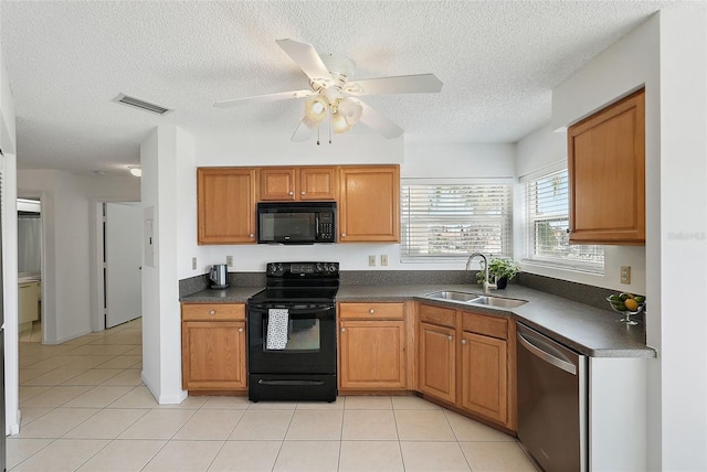 6191 Bahia Del Mar Blvd Unit 204, Saint Petersburg, FL 33715 - kitchen with light tile patterned flooring, black appliances, dark countertops, visible vents, and a sink