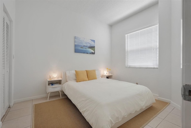 6191 Bahia Del Mar Blvd Unit 204, Saint Petersburg, FL 33715 - bedroom with light tile patterned floors, baseboards, and a textured ceiling