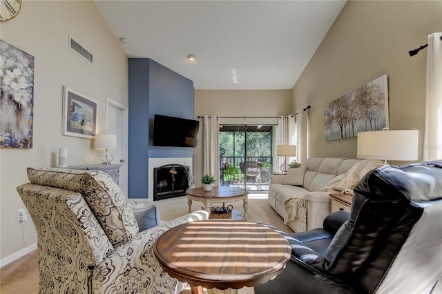 612 Fairmont Ave Unit D, Safety Harbor, FL 34695 - living room with visible vents, baseboards, a fireplace, high vaulted ceiling, and light colored carpet