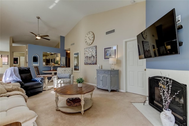 612 Fairmont Ave Unit D, Safety Harbor, FL 34695 - carpeted living area featuring high vaulted ceiling, a fireplace with flush hearth, visible vents, and ceiling fan