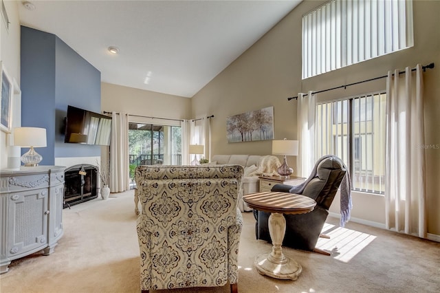 612 Fairmont Ave Unit D, Safety Harbor, FL 34695 - living area featuring baseboards, high vaulted ceiling, light carpet, and a fireplace with flush hearth