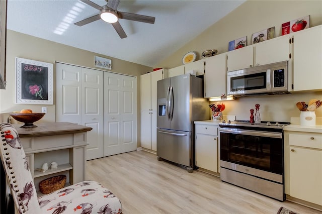 612 Fairmont Ave Unit D, Safety Harbor, FL 34695 - kitchen featuring ceiling fan, light countertops, vaulted ceiling, and stainless steel appliances