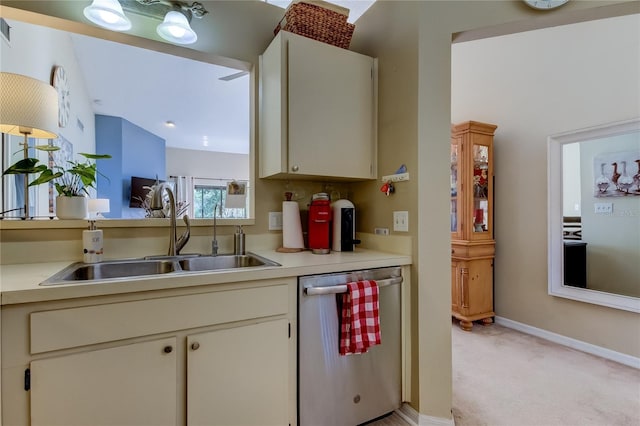612 Fairmont Ave Unit D, Safety Harbor, FL 34695 - kitchen with baseboards, light carpet, light countertops, dishwasher, and a sink