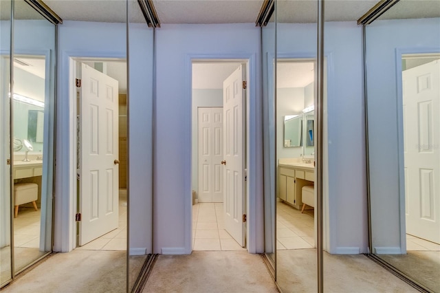 612 Fairmont Ave Unit D, Safety Harbor, FL 34695 - hall with light tile patterned floors, light colored carpet, and a sink