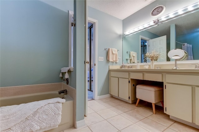 612 Fairmont Ave Unit D, Safety Harbor, FL 34695 - bathroom featuring a bath, a sink, a textured ceiling, double vanity, and tile patterned floors