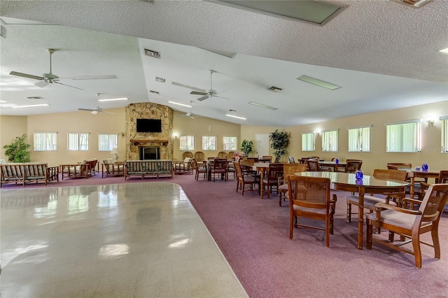 612 Fairmont Ave Unit D, Safety Harbor, FL 34695 - dining room with ceiling fan, a fireplace, vaulted ceiling, and visible vents