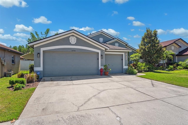 19750 Ellendale Dr, Land O Lakes, FL 34638 - single story home featuring stucco siding, a garage, a front yard, and concrete driveway