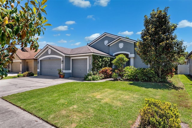 19750 Ellendale Dr, Land O Lakes, FL 34638 - ranch-style house with an attached garage, stucco siding, and driveway
