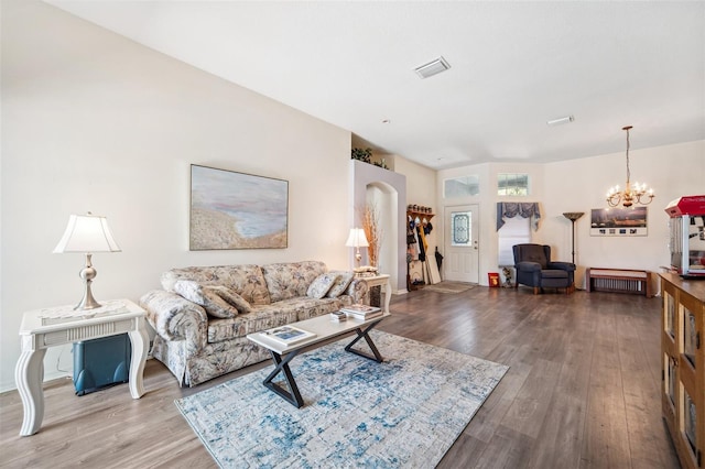 19750 Ellendale Dr, Land O Lakes, FL 34638 - living area featuring a chandelier, wood finished floors, and arched walkways