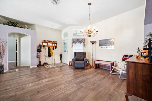 19750 Ellendale Dr, Land O Lakes, FL 34638 - living area with wood finished floors, a chandelier, and arched walkways