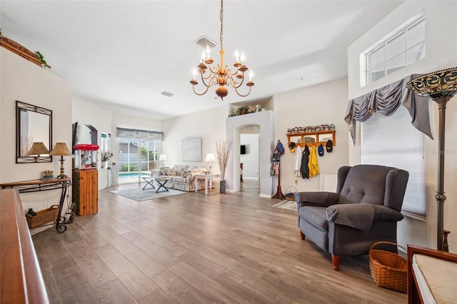 19750 Ellendale Dr, Land O Lakes, FL 34638 - sitting room with arched walkways, a chandelier, and wood finished floors