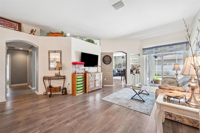 19750 Ellendale Dr, Land O Lakes, FL 34638 - living room featuring arched walkways and wood finished floors