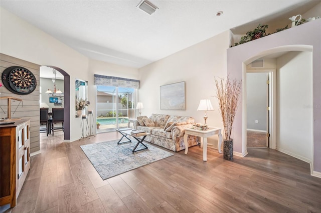 19750 Ellendale Dr, Land O Lakes, FL 34638 - living area with arched walkways and wood finished floors
