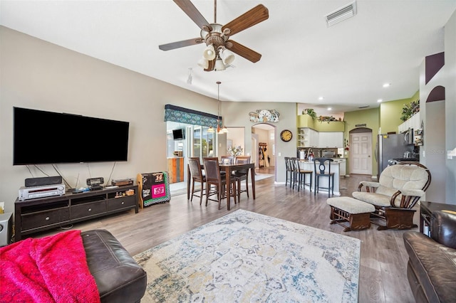 19750 Ellendale Dr, Land O Lakes, FL 34638 - living room with ceiling fan, wood finished floors, arched walkways, and recessed lighting