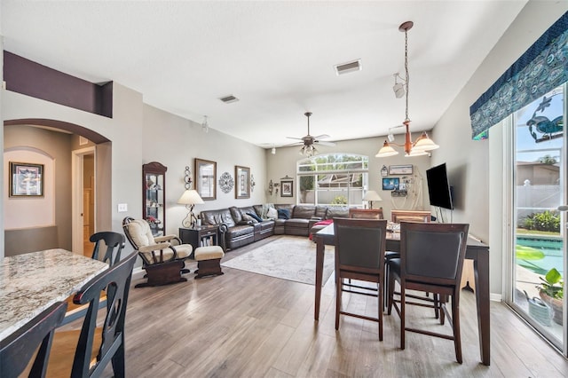 19750 Ellendale Dr, Land O Lakes, FL 34638 - dining space featuring ceiling fan, wood finished floors, and arched walkways