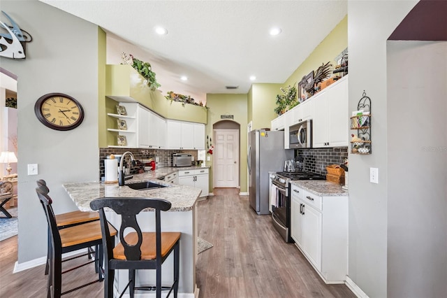 19750 Ellendale Dr, Land O Lakes, FL 34638 - kitchen featuring stainless steel appliances, open shelves, a breakfast bar area, tasteful backsplash, and recessed lighting