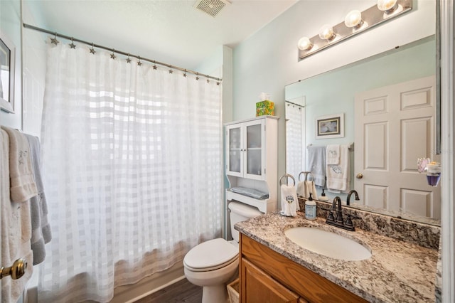 19750 Ellendale Dr, Land O Lakes, FL 34638 - full bathroom featuring vanity, shower / bath combo, and wood finished floors