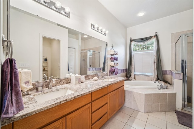 19750 Ellendale Dr, Land O Lakes, FL 34638 - full bath with a stall shower, a bath, double vanity, and tile patterned flooring