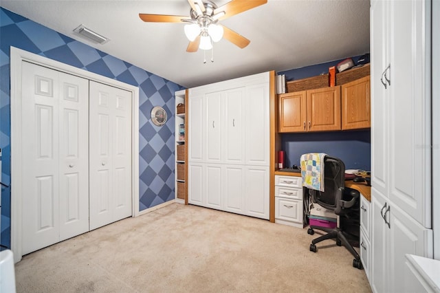 19750 Ellendale Dr, Land O Lakes, FL 34638 - office featuring light colored carpet, ceiling fan, wallpapered walls, and built in study area