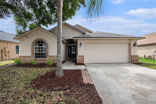 6711 Thackston Dr, Riverview, FL 33578 - view of front of property featuring brick siding, a garage, concrete driveway, a shingled roof, and stucco siding