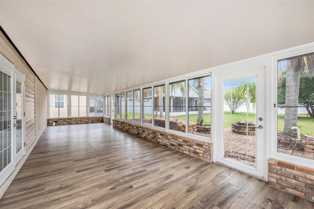 6711 Thackston Dr, Riverview, FL 33578 - unfurnished sunroom featuring wood finished floors and a fire pit