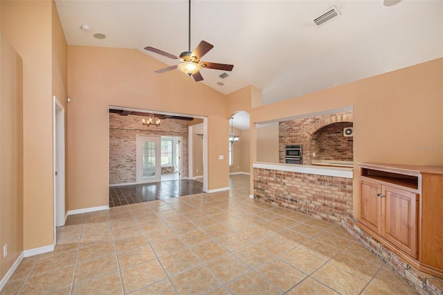 6711 Thackston Dr, Riverview, FL 33578 - unfurnished living room featuring a ceiling fan, vaulted ceiling, a chandelier, light tile patterned floors, and arched walkways