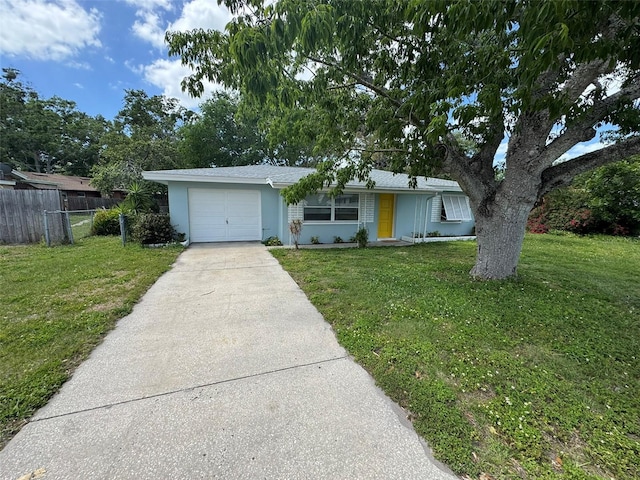 single story home featuring a front yard, an attached garage, concrete driveway, fence, and stucco siding